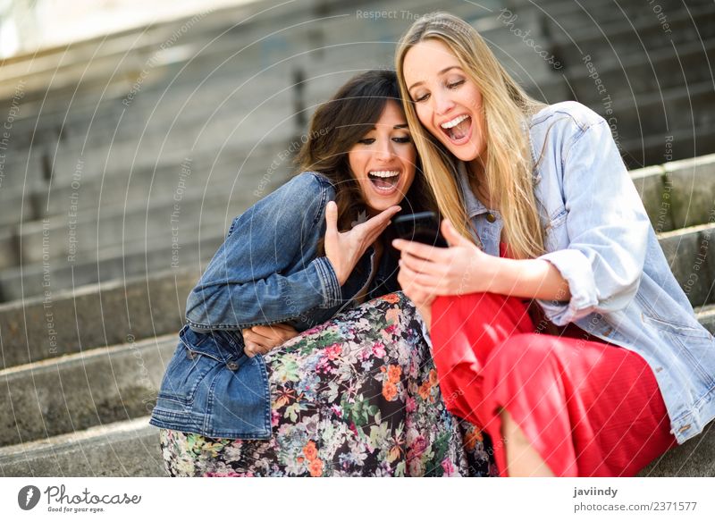 Two young women looking at funny things on smartphone Lifestyle Shopping Joy Happy Beautiful Telephone Technology Feminine Woman Adults Friendship