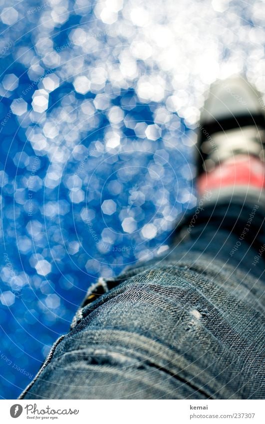 Sitting at the fountain Well-being Relaxation Leisure and hobbies Human being Adults Life Legs Feet 1 Water Drops of water Summer Jeans Footwear Chucks