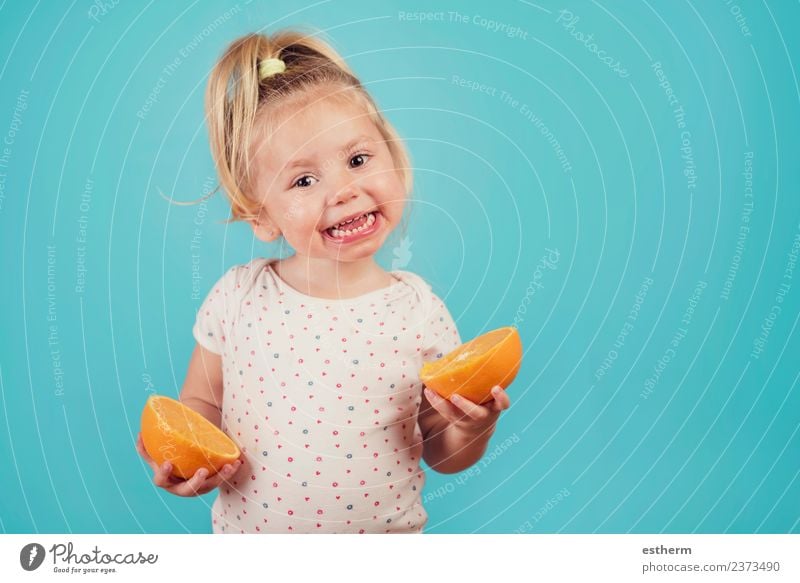 smiling baby with an orange on blue background Food Fruit Orange Nutrition Eating Lifestyle Joy Human being Feminine Baby Girl Infancy 1 3 - 8 years Child