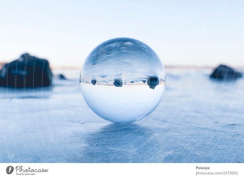 Glass orb balancing on ice on a frozen lake Design Beautiful Wellness Meditation Winter Snow Mountain Decoration Nature Landscape Sky Tree Rock Lake Globe