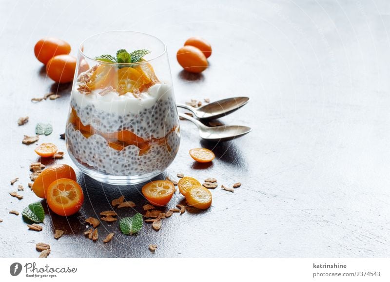 Chia pudding parfait, layered with kumquat and granola Yoghurt Fruit Dessert Eating Breakfast Diet Bowl Spoon Dark Bright Green White Colour Cereal chia Pudding