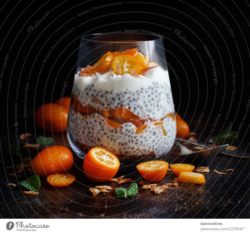 Chia pudding parfait, layered with kumquat and granola Yoghurt Fruit Dessert Eating Breakfast Diet Bowl Spoon Dark Bright Green White Colour Cereal chia Pudding