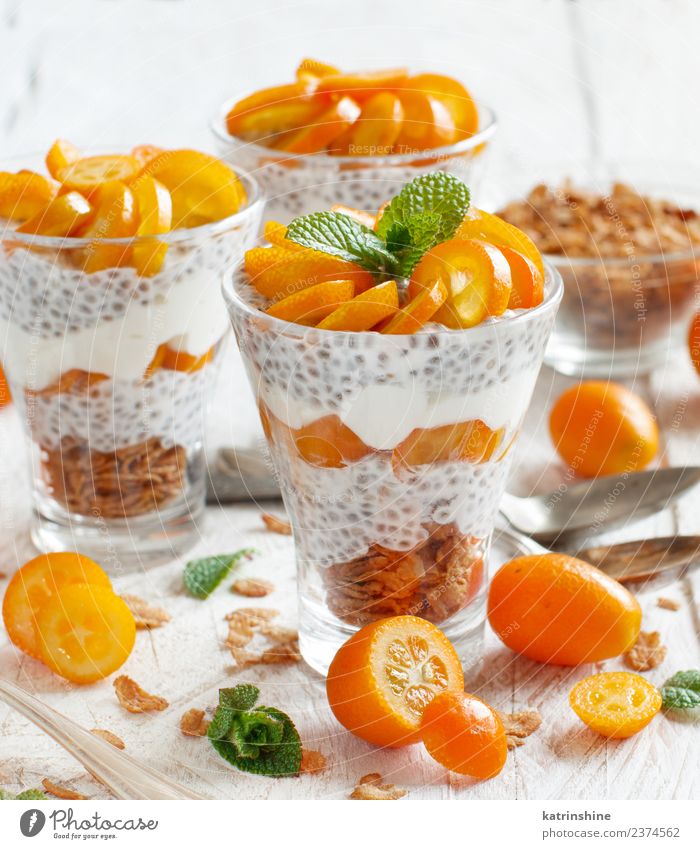 Chia pudding parfait, layered with kumquat and granola Yoghurt Fruit Dessert Eating Breakfast Diet Bowl Spoon Bright Green White Colour Cereal chia Pudding seed