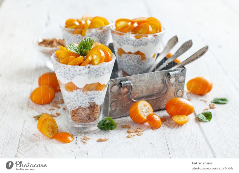 Chia pudding parfait, layered with kumquat and granola Yoghurt Fruit Dessert Eating Breakfast Diet Bowl Spoon Bright Green White Colour Cereal chia Pudding seed