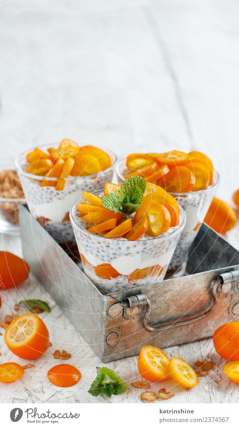 Chia pudding parfait, layered with kumquat and granola Yoghurt Fruit Dessert Eating Breakfast Diet Bowl Spoon Metal Bright Green White Colour Cereal chia