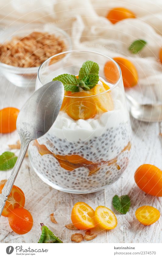 Chia pudding parfait, layered with kumquat and granola Yoghurt Fruit Dessert Eating Breakfast Diet Bowl Spoon Bright Green White Colour Cereal chia Pudding seed