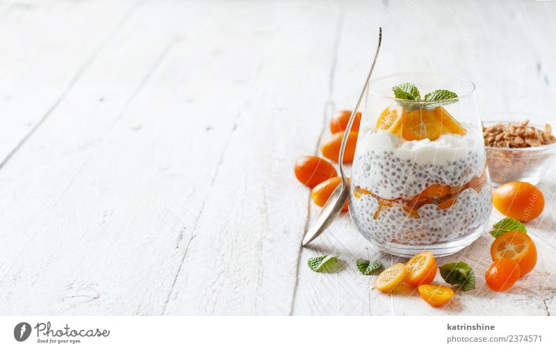 Chia pudding parfait, layered with kumquat and granola Yoghurt Fruit Dessert Eating Breakfast Diet Bowl Spoon Bright Green White Colour Cereal chia Pudding seed