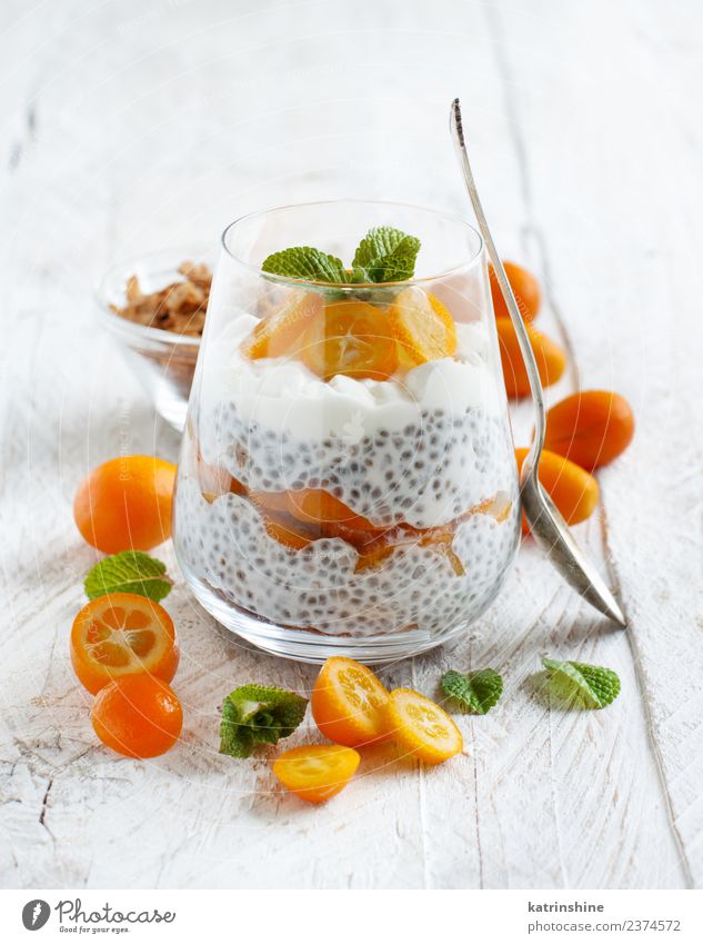 Chia pudding parfait, layered with kumquat and granola Yoghurt Fruit Dessert Eating Breakfast Diet Bowl Spoon Bright Green White Colour Cereal chia Pudding seed