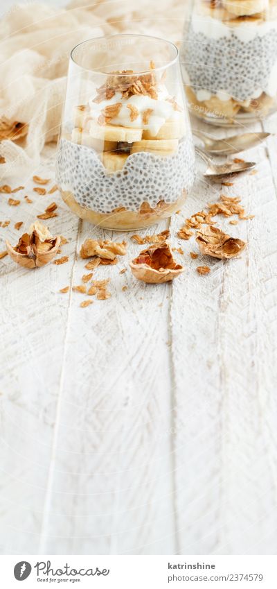 Chia pudding parfait, layered with banana and granola Yoghurt Fruit Dessert Eating Breakfast Diet Bowl Spoon White Cereal chia Pudding seed Dairy glass Gourmet