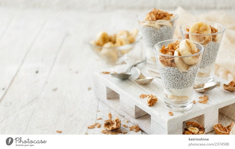 Chia pudding parfait, layered with banana and granola Yoghurt Fruit Dessert Eating Breakfast Diet Bowl Spoon White Cereal chia Pudding seed Dairy glass Gourmet