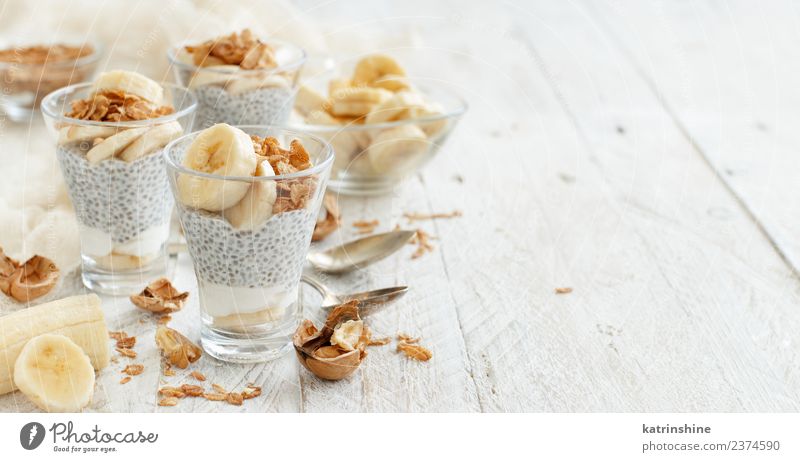 Chia pudding parfait, layered with banana and granola Yoghurt Fruit Dessert Eating Breakfast Diet Bowl Spoon White Cereal chia Pudding seed Dairy glass Gourmet