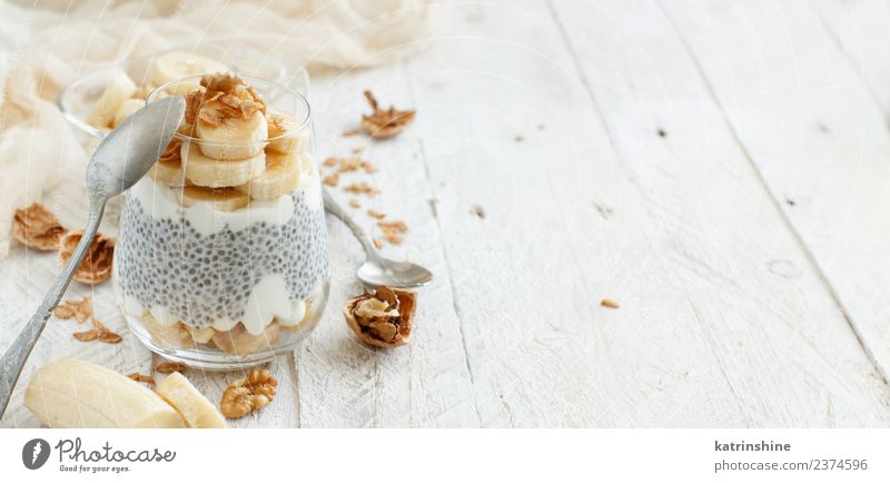 Chia pudding parfait, layered with banana and granola Yoghurt Fruit Dessert Eating Breakfast Diet Bowl Spoon White Cereal chia Pudding seed Dairy glass Gourmet