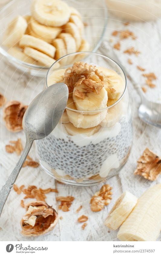 Chia pudding parfait, layered with banana and granola Yoghurt Fruit Dessert Eating Breakfast Diet Bowl Spoon White Cereal chia Pudding seed Dairy glass Gourmet