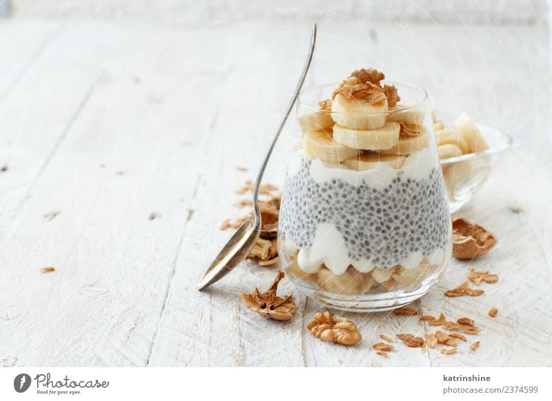 Chia pudding parfait, layered with banana and granola Yoghurt Fruit Dessert Eating Breakfast Diet Bowl Spoon White Cereal chia Pudding seed Dairy glass Gourmet