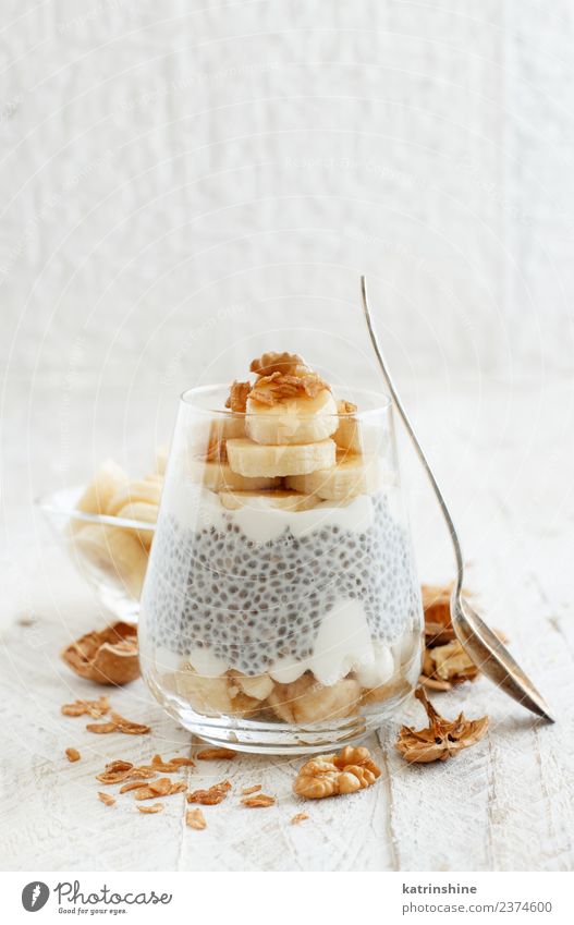 Chia pudding parfait, layered with banana and granola Yoghurt Fruit Dessert Eating Breakfast Diet Bowl Spoon White Cereal chia Pudding seed Dairy glass Gourmet