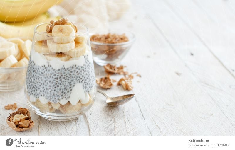 Chia pudding parfait, layered with banana and granola Yoghurt Fruit Dessert Eating Breakfast Diet Bowl Spoon White Cereal chia Pudding seed Dairy glass Gourmet