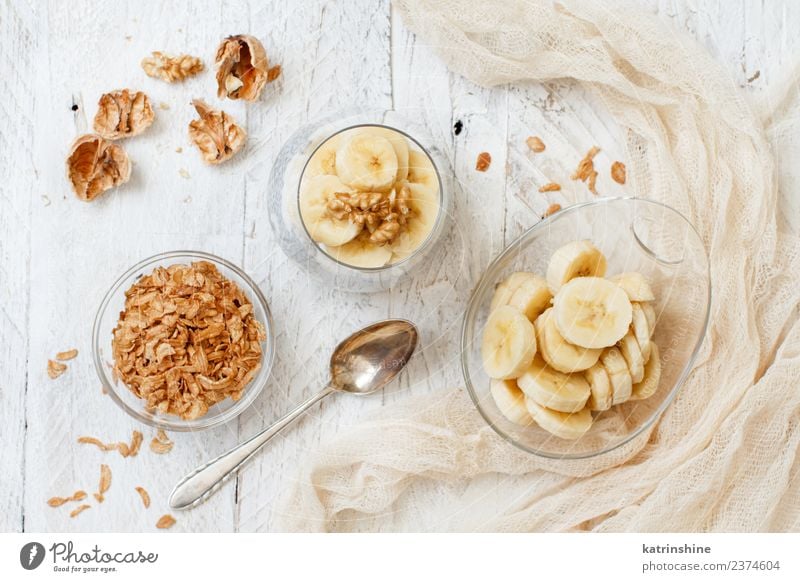 Chia pudding parfait, layered with banana and granola Yoghurt Fruit Dessert Eating Breakfast Diet Bowl Spoon White Cereal chia Pudding seed Dairy glass Gourmet