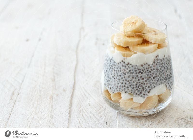 Chia pudding parfait, layered with banana and granola Yoghurt Fruit Dessert Eating Breakfast Diet Bowl Spoon White Cereal chia Pudding seed Dairy glass Gourmet