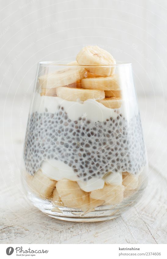 Chia pudding parfait, layered with banana and granola Yoghurt Fruit Dessert Eating Breakfast Diet Bowl Spoon White Cereal chia Pudding seed Dairy glass Gourmet