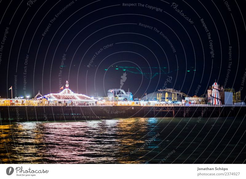 Brighton Palace Pier illuminated at night, England Lighting Night Multicoloured Reflection Water Jetty Footbridge Fairs & Carnivals Entertainment Dark Ocean