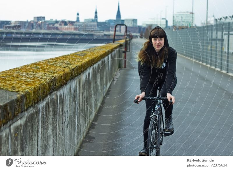 Young woman riding bicycle in Hamburg Movement Bicycle Cycling Port City Town Subculture Adults Youth (Young adults) portrait Exceptional Driving Colour photo