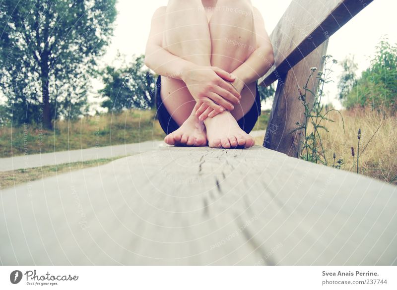 Lonely. Skin Arm Hand Fingers Legs Feet 1 Human being Bench Sit Uniqueness Natural Duck down Tree Meadow Colour photo Exterior shot Crouch Feminine Cross