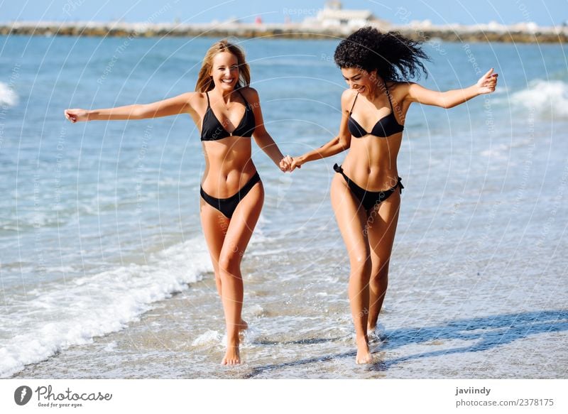 Two young women in bikini on a tropical beach. Lifestyle Joy Happy Beautiful Body Hair and hairstyles Leisure and hobbies Vacation & Travel Tourism Summer Beach