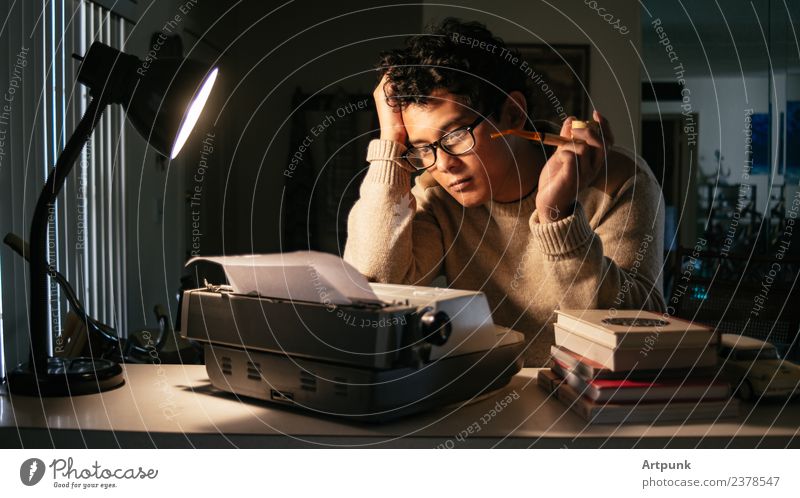 A young man sitting in front of a typewriter Typewriter 18 - 30 years Young man Man Asians Writer Lamp Work and employment Literature Pipe Smoking Book