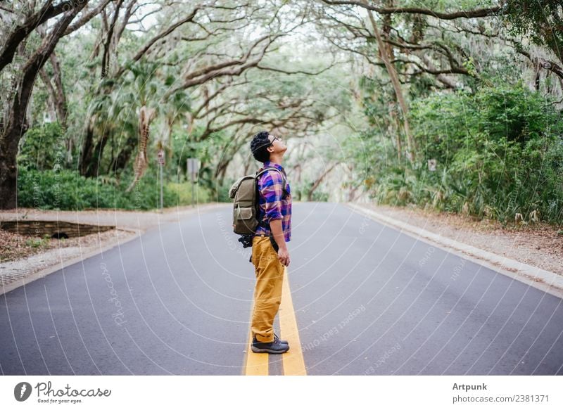 A hiker in the middle of the road Hiking Backpack Street Vacation & Travel Nature Tree Forest Adventure Boots Wanderlust Camping Middle Trip Road sign Profile