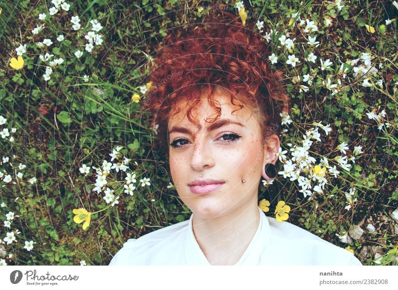 Young redhead woman lying down over a field of flowers Lifestyle Style Beautiful Hair and hairstyles Skin Face Freckles Senses Relaxation Fragrance Human being