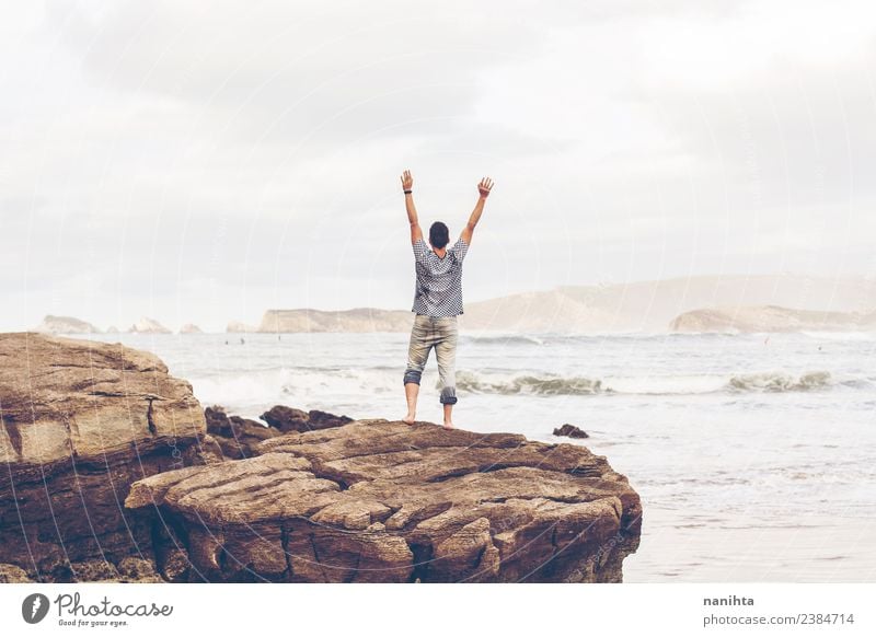 Young man alone in front of the sea Lifestyle Healthy Vacation & Travel Tourism Trip Adventure Far-off places Freedom Summer Summer vacation Beach Ocean Waves