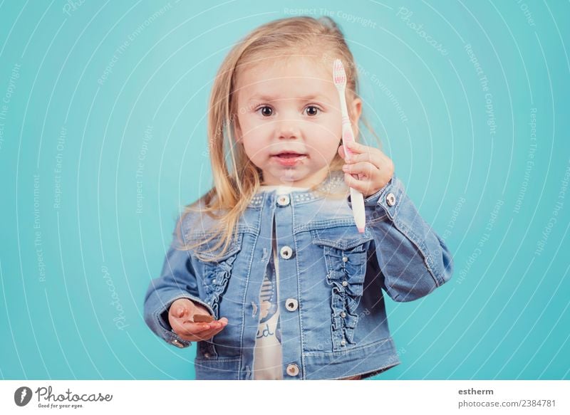 little girl with toothbrush on blue background Joy Personal hygiene Human being Feminine Baby Girl Infancy 1 3 - 8 years Child Toothbrush To hold on Fitness