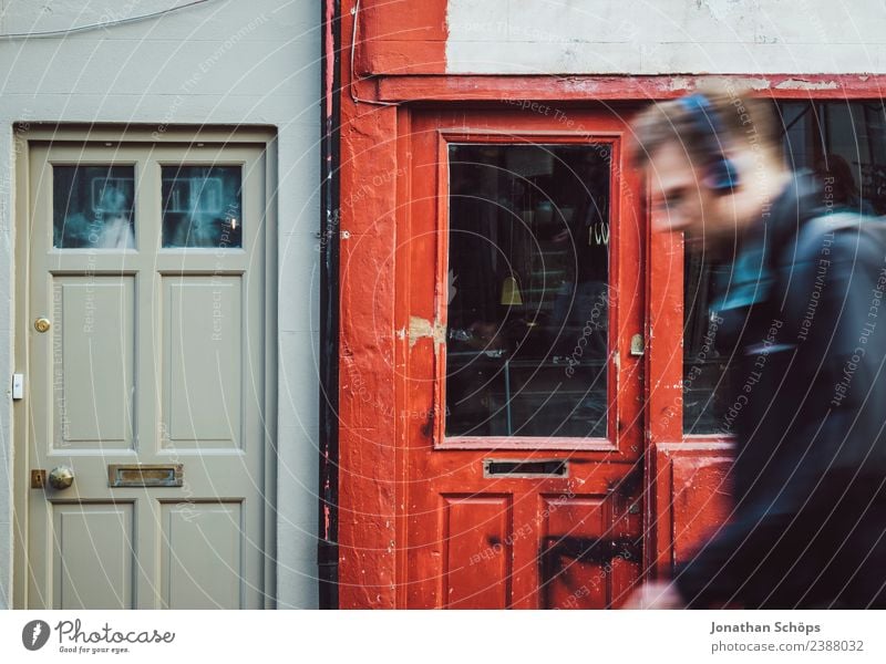 Man walks in front of red wooden facade, shop, Brighton, England Wooden facade Load Exterior shot Colour photo Town Esthetic House (Residential Structure)