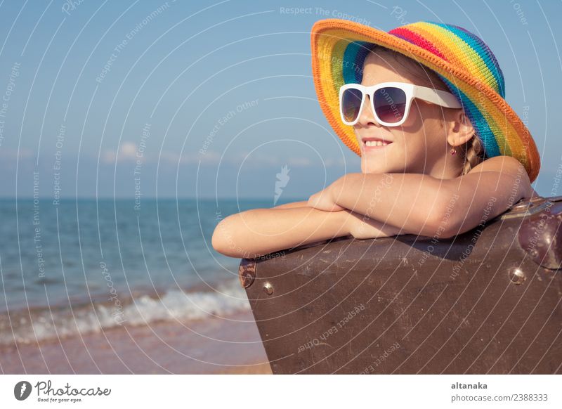 One happy little girl with suitcase sitting on the beach Lifestyle Joy Happy Relaxation Leisure and hobbies Playing Vacation & Travel Tourism Trip Adventure