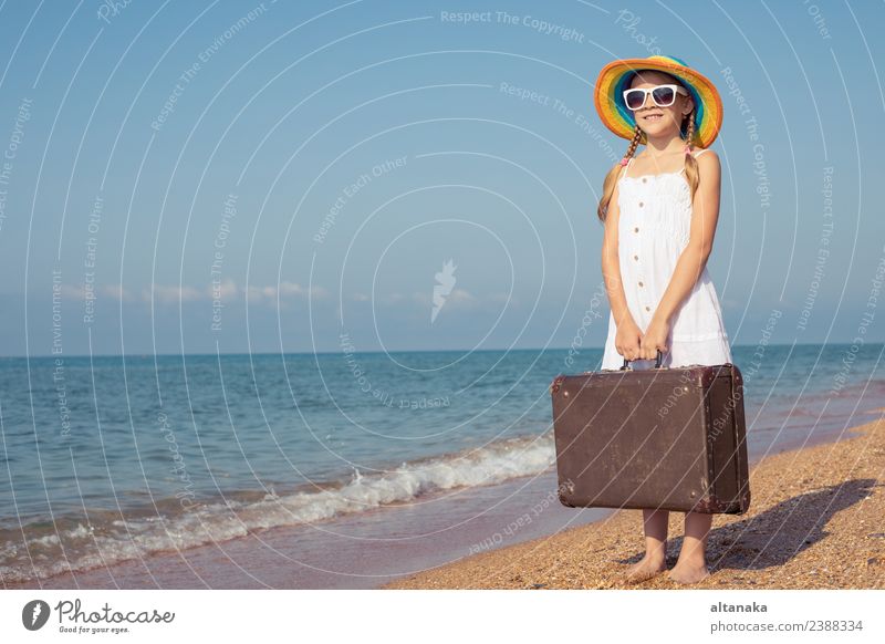 One happy little girl with suitcase standing on the beach. Lifestyle Joy Happy Relaxation Leisure and hobbies Playing Vacation & Travel Tourism Trip Adventure