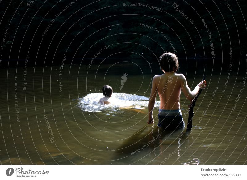 two children bathing in dark water Boy (child) Adventure be afloat bathe Freedom Experiencing nature Summer Water urge for freedom Swimming & Bathing