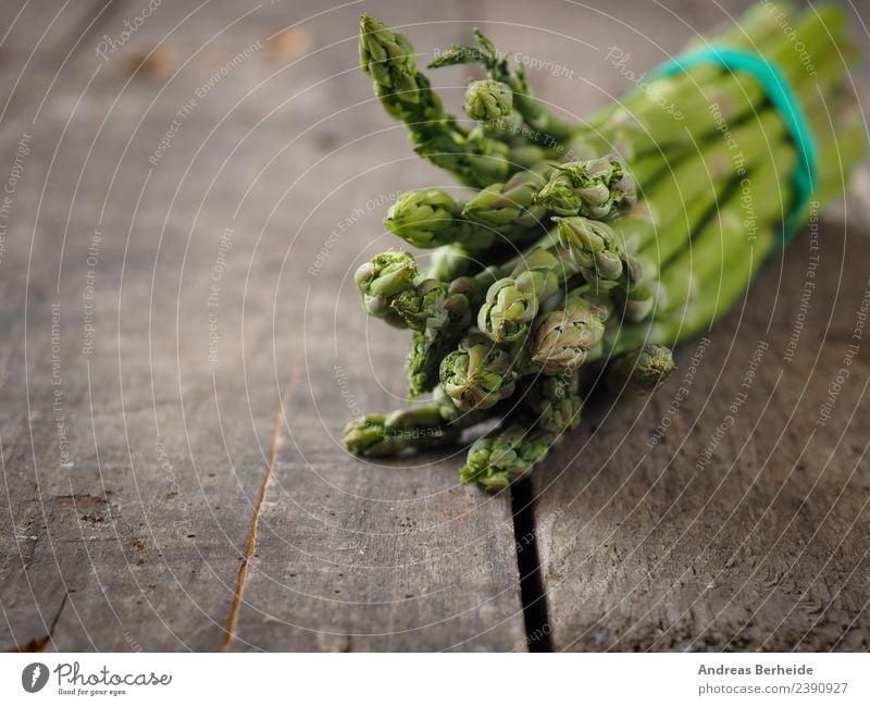 Green organic asparagus on a wooden table Food Vegetable Organic produce Vegetarian diet Diet Spring Delicious Healthy antioxidant Asparagus Background picture