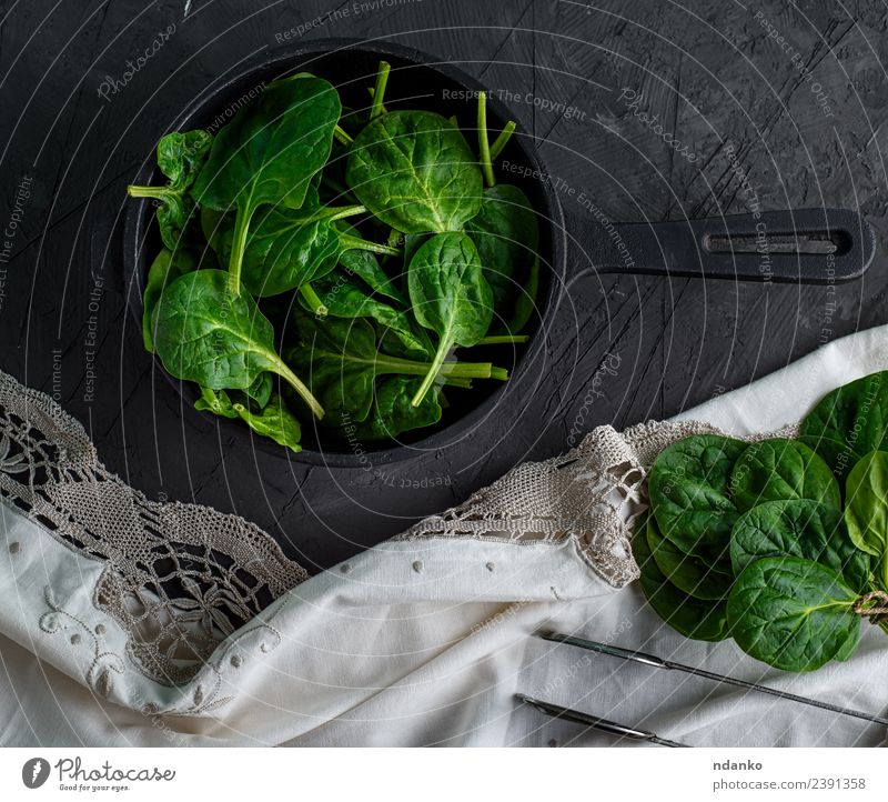 spinach in a round cast-iron frying pan Vegetable Herbs and spices Nutrition Vegetarian diet Diet Pan Nature Plant Leaf Eating Fresh Natural Above Green Black