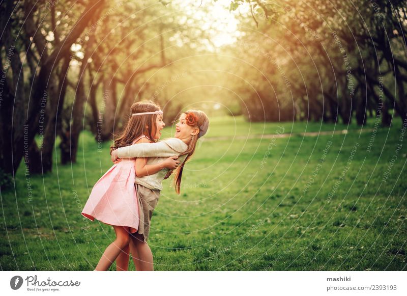 two happy kid girlfriends playing Apple Lifestyle Joy Relaxation Playing Vacation & Travel Summer Child To talk Sister Friendship Infancy Nature Grass Smiling