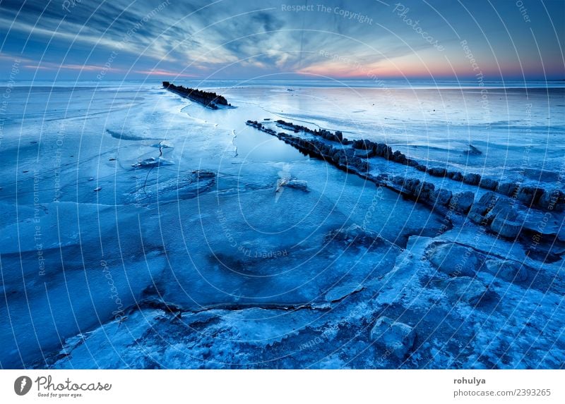 old wooden breakwater on frozen coast in dusk Vacation & Travel Beach Snow Nature Landscape Sky Horizon Sunrise Sunset Winter Weather Beautiful weather Storm