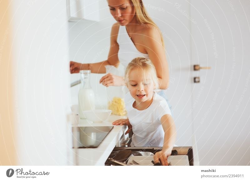 mother having breakfast with daughter Breakfast Lifestyle Joy Happy Kitchen Child Mother Adults Family & Relations Smiling Embrace Together Modern White