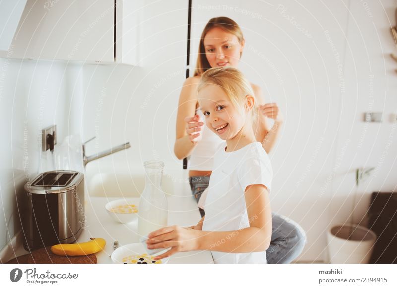 mother having breakfast with daughter Breakfast Lifestyle Joy Happy Kitchen Child Mother Adults Family & Relations Smiling Embrace Together Modern White