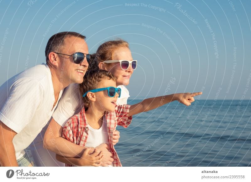 Happy family standing on the beach at the day time. Lifestyle Joy Relaxation Leisure and hobbies Playing Vacation & Travel Trip Freedom Camping Summer Beach