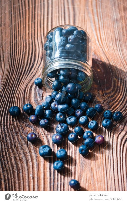 Freshly gathered blueberries put into jar Food Fruit Nutrition Organic produce Vegetarian diet Diet Bowl Summer Table Nature Wood Authentic Delicious Natural