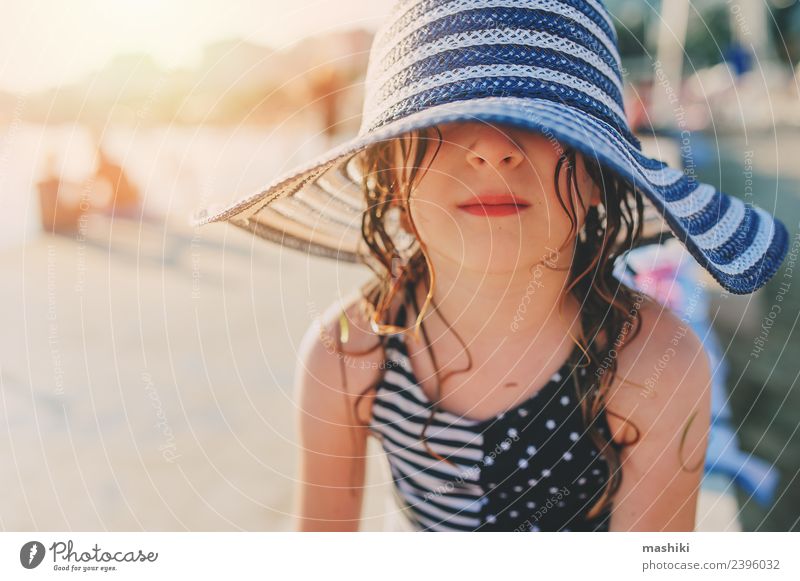 happy child relaxing on summer beach Lifestyle Joy Relaxation Vacation & Travel Summer Sun Beach Ocean Child Infancy Hand Warmth Coast Hat Stripe To enjoy Wet