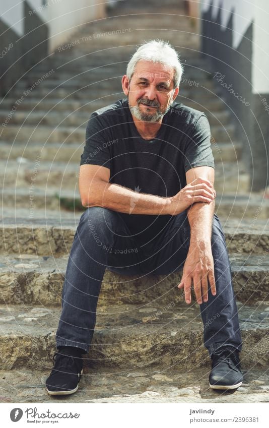 Mature man sitting on steps in the street. Lifestyle Happy Human being Masculine Man Adults Male senior Senior citizen 1 45 - 60 years 60 years and older Street