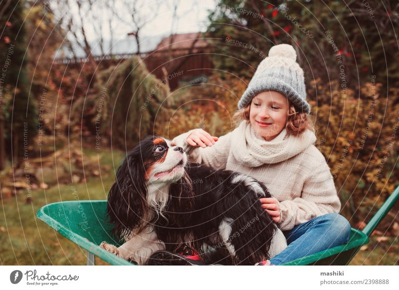 funny child girl riding her dog in wheelbarrow Lifestyle Joy Playing Garden Child Friendship Infancy Autumn Weather Sweater Pet Dog Happiness fall Wheelbarrow