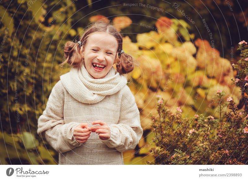 happy kid girl playing in autumn garden Joy Happy Playing Knit Vacation & Travel Garden Child Work and employment Nature Autumn Warmth Flower Leaf Sweater Scarf