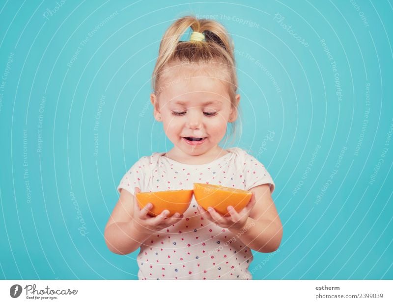 smiling baby with an orange on blue background Food Fruit Orange Nutrition Eating Lifestyle Joy Wellness Human being Feminine Baby Girl Infancy 1 3 - 8 years