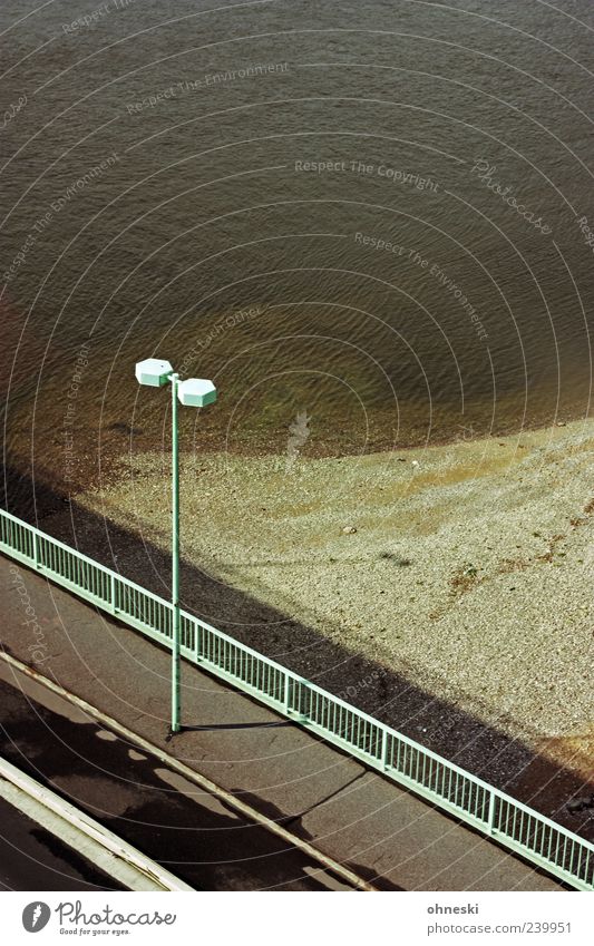 Gondola view [Cologne] River bank Rhine Deserted Bridge Traffic infrastructure Street Bridge railing Street lighting Lantern Colour photo Copy Space right